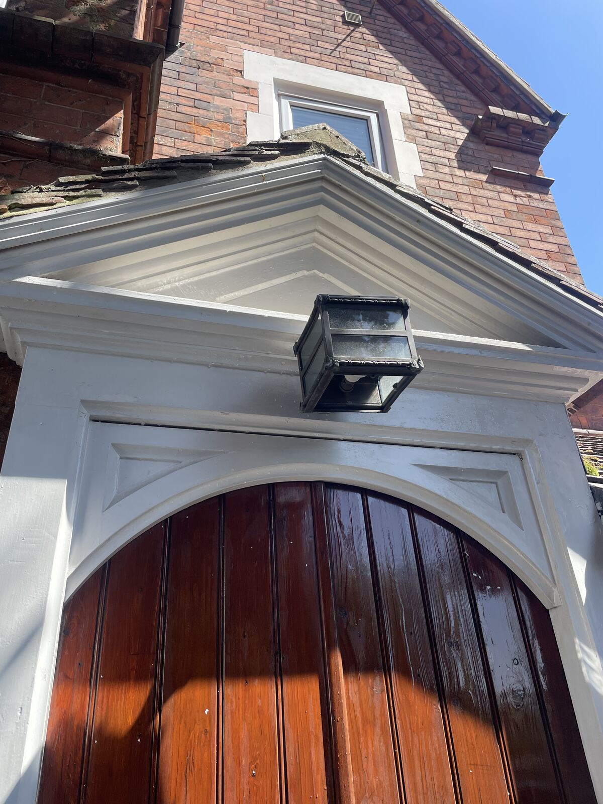 Dirty rendering above a porch entrance before cleaning